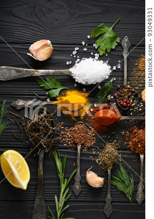 Colorful various herbs and spices for cooking on dark wooden rustic background 93049331