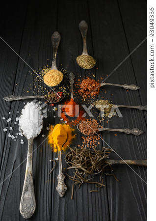 Colorful various herbs and spices for cooking on dark wooden rustic background 93049336