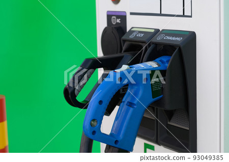 Electric Car Charging Gun at Charging Station Electric Car Charging Gun at Charging Station 93049385