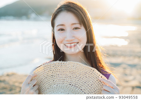 Young woman relaxing on the beach Young woman relaxing on the beach 93049558
