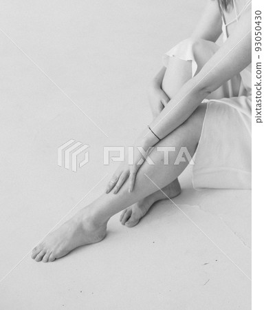 beautiful girl ballerina doing leg warm up 93050430