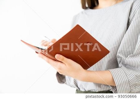 Young businesswoman with notebook 93050666