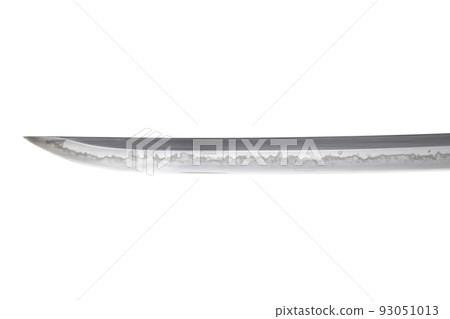 Japanese sword blade (made in China) on white background. Soft focus.  The wavy pattern on the blade edge is a line of hardness that a blacksmith makes so that the blade doesn't break. 93051013