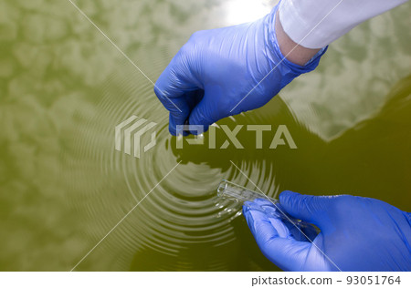 Water sample. Checking the condition of rivers or natural lakes. Water test for chemicals, bacteria, harmful substances, radiation. Collection of material in a test tube for further research. Water sample. Checking the condition of rivers or natural lakes. Water test for chemicals, bacteria, harmful substances, radiation. Collection of material in a test tube for further research. 93051764