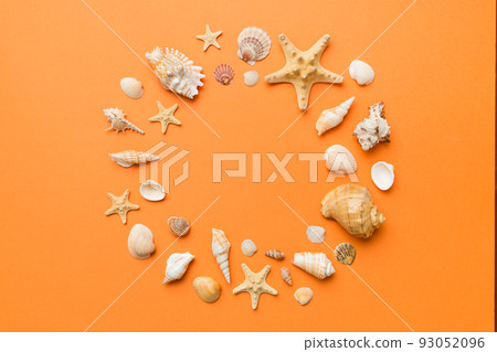 Summer time concept on colored background. Seashells from ocean shore in the shape of frame separated with space for text top view Summer time concept on colored background. Seashells from ocean shore in the shape of frame separated with space for text top view 93052096