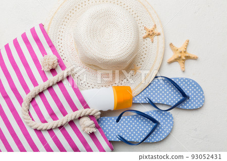beach accessories flat lay top view on colored background Summer travel concept. Bag with starfish and sea shell. Top view beach accessories flat lay top view on colored background Summer travel concept. Bag with starfish and sea shell. Top view 93052431