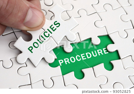 The human hand fills the last missing elements of the surface from the jigsaw puzzle. Image with words policies and procedure The human hand fills the last missing elements of the surface from the jigsaw puzzle. Image with words policies and procedure 93052825