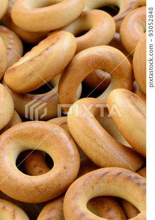 Close-up photo of fresh yellow bagels. A popular kind of flour products. One of the traditional Russian treats for tea Close-up photo of fresh yellow bagels. A popular kind of flour products. One of the traditional Russian treats for tea 93052848