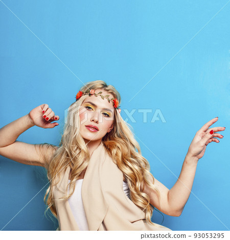 young blond woman dressed like ancient greek godess, beautiful girl hands manicured red nails on blue background copyspace close up young blond woman dressed like ancient greek godess, beautiful girl hands manicured red nails on blue background copyspace close up 93053295