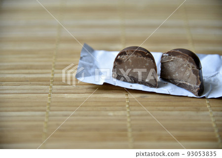 Black delicious chocolates mat close on white background. Healthy lifestyle, sport. Fitness workout. Black delicious chocolates mat close on white background. Healthy lifestyle, sport. Fitness workout. 93053835