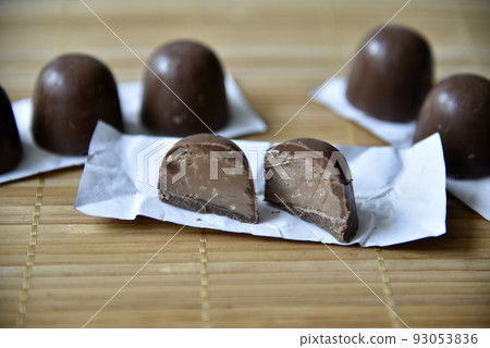 Black delicious chocolates mat close on white background. Healthy lifestyle, sport. Fitness workout. Black delicious chocolates mat close on white background. Healthy lifestyle, sport. Fitness workout. 93053836