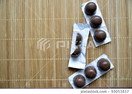 Black delicious chocolates mat close on white background. Healthy lifestyle, sport. Fitness workout. Black delicious chocolates mat close on white background. Healthy lifestyle, sport. Fitness workout. 93053837