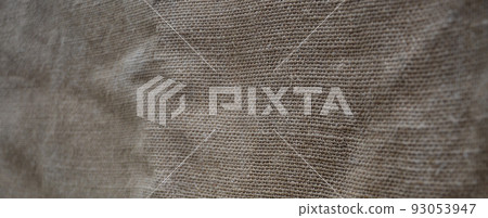 The texture of a very old brown sack cloth. Retro texture with canvas material. Background image with copy space 93053947