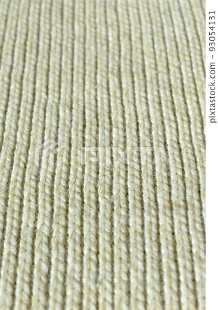 Fabric texture of a soft yellow knitted sweater. Macro image of the structure of bindings in yarns Fabric texture of a soft yellow knitted sweater. Macro image of the structure of bindings in yarns 93054131