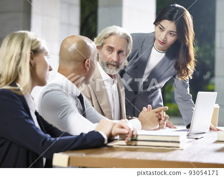 multiethnic team of corporate executives meeting in office multiethnic team of corporate executives meeting in office 93054171