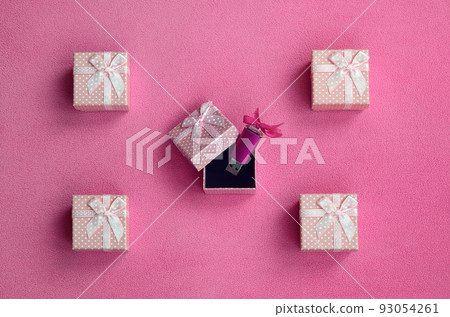 Brilliant pink usb flash memory card with a pink bow lies in a small gift box in pink with a small bow on a blanket of soft and furry light pink fleece fabric. Classic female gift memory card design Brilliant pink usb flash memory card with a pink bow lies in a small gift box in pink with a small bow on a blanket of soft and furry light pink fleece fabric. Classic female gift memory card design 93054261