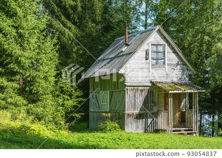 Ancient wooden house in the summer forest. 93054837