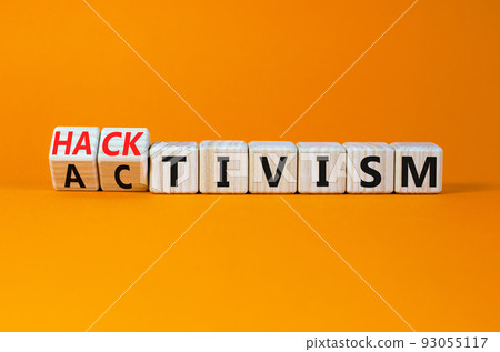 Activism or hacktivism symbol. Turned wooden cubes and changed the concept word Activism to Hacktivism. Beautiful orange table orange background, copy space. Business activism or hacktivism concept. Activism or hacktivism symbol. Turned wooden cubes and changed the concept word Activism to Hacktivism. Beautiful orange table orange background, copy space. Business activism or hacktivism concept. 93055117