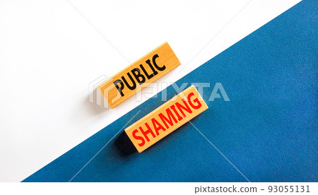 Public shaming symbol. Concept words Public shaming on wooden blocks on a beautiful white and blue background. Business and public shaming concept. Copy space. Public shaming symbol. Concept words Public shaming on wooden blocks on a beautiful white and blue background. Business and public shaming concept. Copy space. 93055131