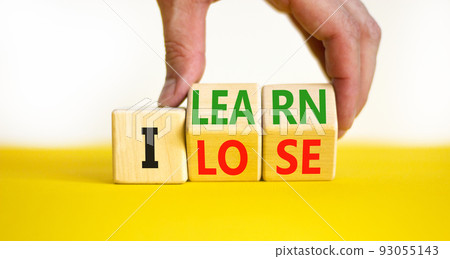 I learn or lose symbol. Concept words I learn and I lose on wooden cubes. Businessman hand. Beautiful yellow table white background. Business and i learn or lose concept. Copy space. 93055143