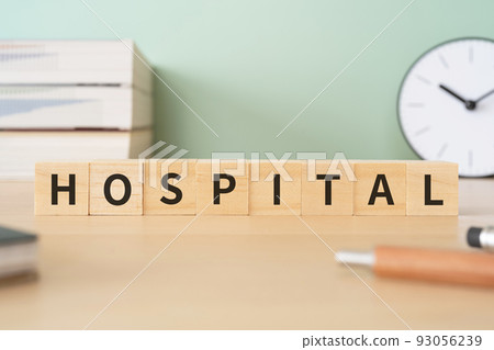 Image of a hospital | A desk with a block written "HOSPITAL" 93056239