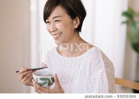 Middle Japanese woman having a meal Middle Japanese woman having a meal 93056369