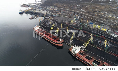 Port filled with coal, waiting for ships to start loading. Murmansk, Russia. Drone view Port filled with coal, waiting for ships to start loading. Murmansk, Russia. Drone view 93057443