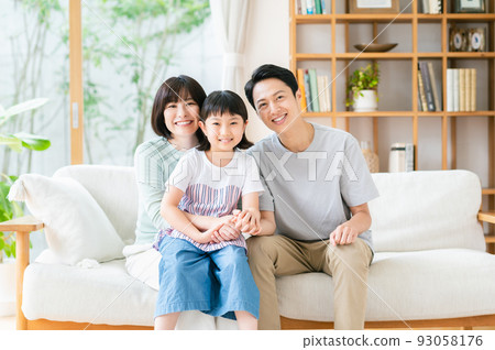 A family relaxing in the living room 93058176