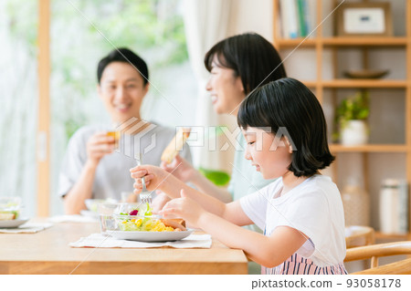 family having breakfast in the living room family having breakfast in the living room 93058178
