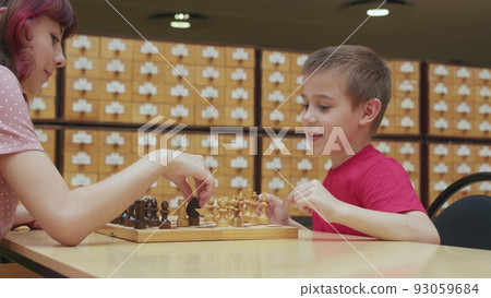 4K. Children play chess in the library 4K. Children play chess in the library 93059684