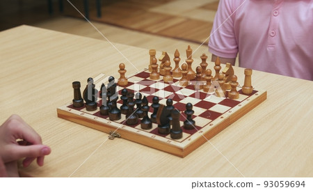 4K. Children play chess in the library 4K. Children play chess in the library 93059694