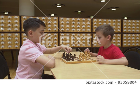 4K. Children play chess in the library 4K. Children play chess in the library 93059804