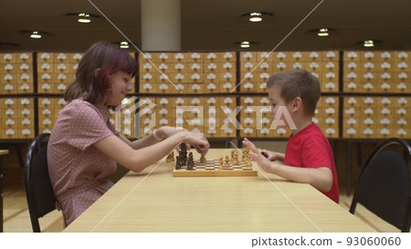 4K. Children play chess in the library 4K. Children play chess in the library 93060060