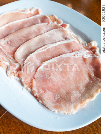 Freshness pork slices on dish. 93061928
