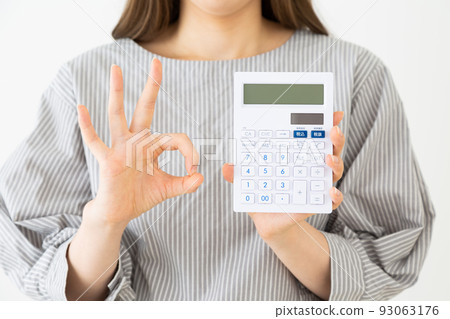 A young lady with a calculator 93063176