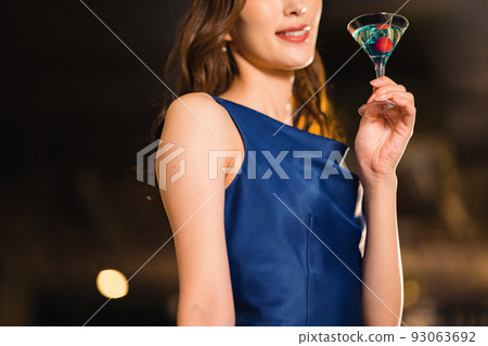 Beautiful woman drinking a cocktail at the bar Beautiful woman drinking a cocktail at the bar 93063692