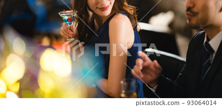 A beautiful woman drinking with a bearded man in his 40s A beautiful woman drinking with a bearded man in his 40s 93064014