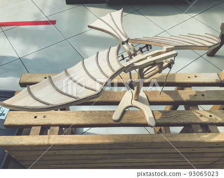 aircraft model made of natural wood. small plane with wings and wooden slats. children's toy, the plane stands on a pedestal 93065023