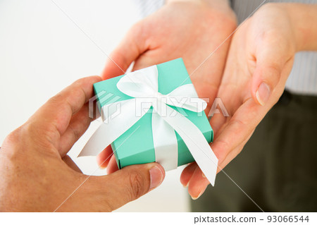 Young woman with a small gift box of presents 93066544