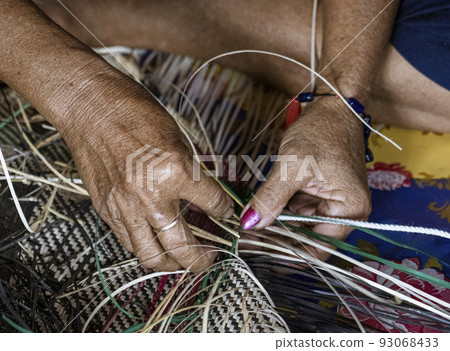 Central Kalamantan, Indonesia; May 20, 2022 - Woman makes baskets by hand Central Kalamantan, Indonesia; May 20, 2022 - Woman makes baskets by hand 93068433