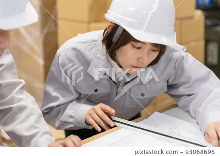 Engineer meeting while looking at drawings Engineer meeting while looking at drawings 93068698