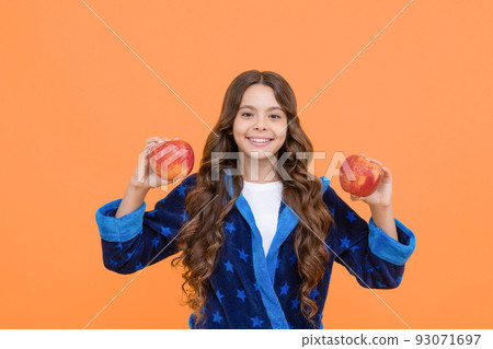 my nutritional choice. cheerful teenage girl going eat apple. toothy child in sleepwear. my nutritional choice. cheerful teenage girl going eat apple. toothy child in sleepwear. 93071697