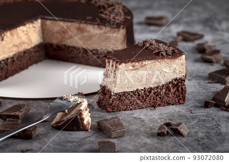Classic mousse cappuccino cake on a gray background decorated with chocolate 93072080