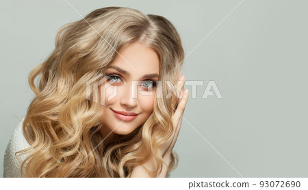 Blonde beauty. Lovely young woman smiling 93072690