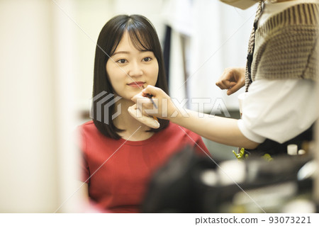 Young model getting hair made Young model getting hair made 93073221