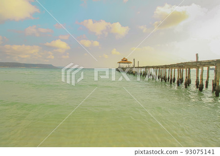 Dreamy summer scene of a wooden boardwalk leading to the vast sea horizon in Koh Rong island in Cambodia, a popular travel destination Dreamy summer scene of a wooden boardwalk leading to the vast sea horizon in Koh Rong island in Cambodia, a popular travel destination 93075141