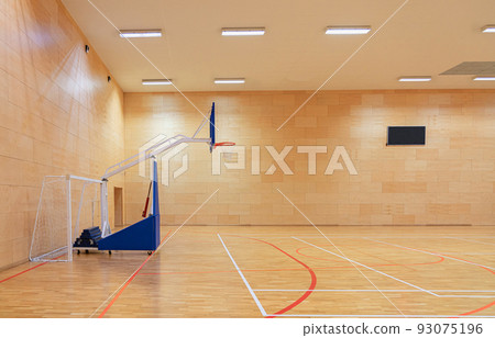 Gym with a mobile basketball hoop and goals for handball and futsal Gym with a mobile basketball hoop and goals for handball and futsal 93075196