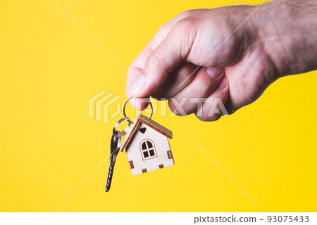 Buying a house. The buyer receives the key to the property. Buying a house. The buyer receives the key to the property. 93075433