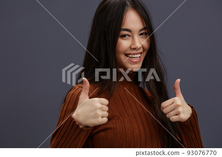 young woman fun brown sweater posing casual wear Gray background young woman fun brown sweater posing casual wear Gray background 93076770
