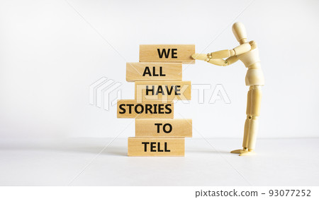 We all have stories to tell symbol. Wooden blocks with words 'We all have stories to tell'. Businessman model. Beautiful white background. Business, popular quotation concept. Copy space. 93077252